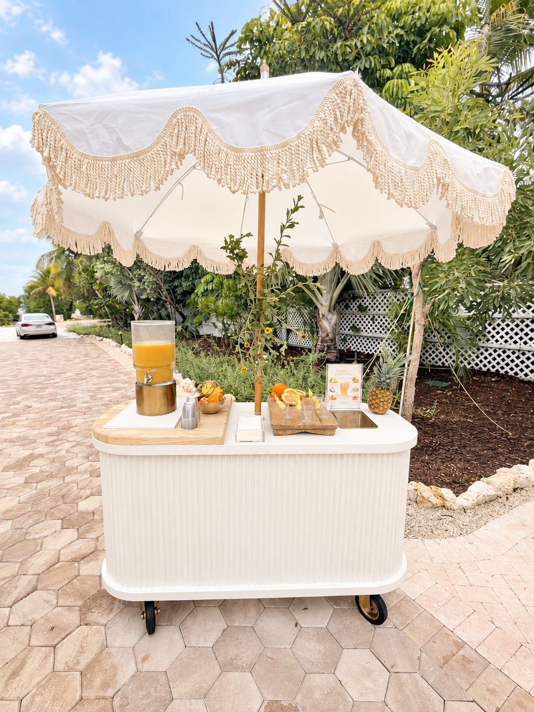 Fringed umbrella cart serving a tropical citrus drink at the wellness retreat