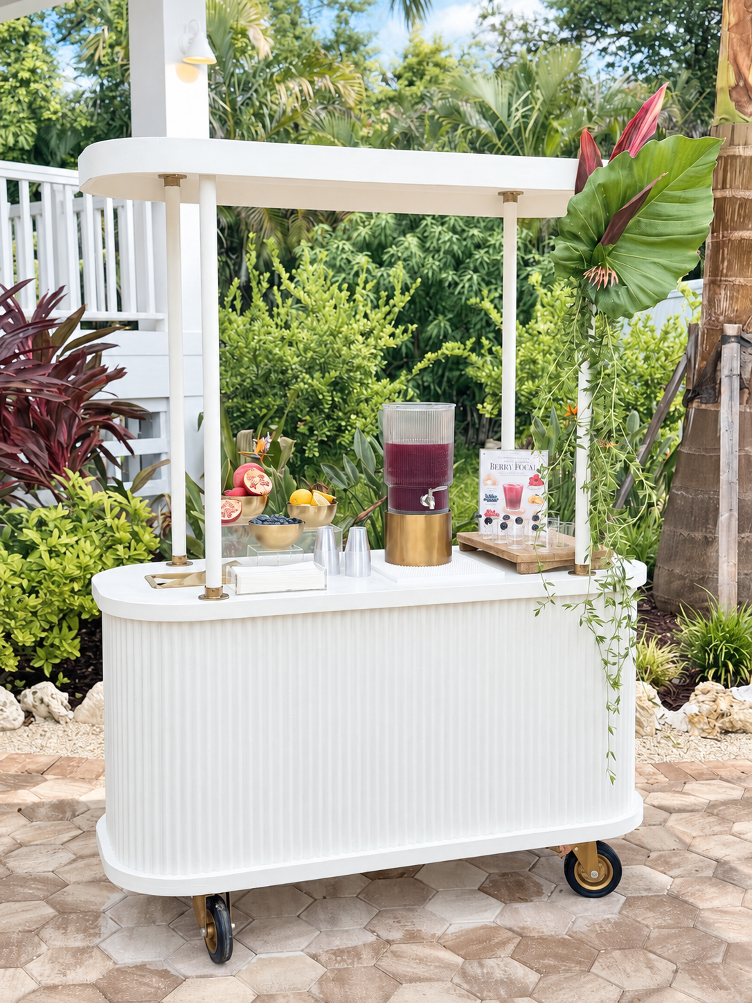 White Cart Haus beverage cart serving a berry wellness drink