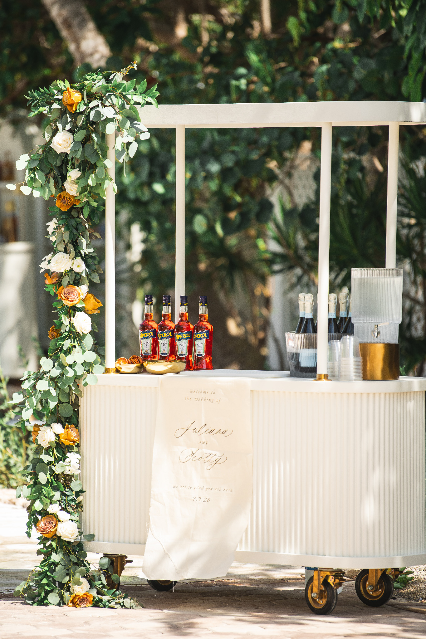 White Cart Haus serving cart styled with florals and Aperol
